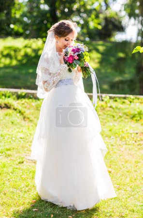 Wedding flowers ,Woman holding colorful bouquet with her hands on wedding day