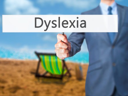 Dyslexia - Businessman hand holding sign
