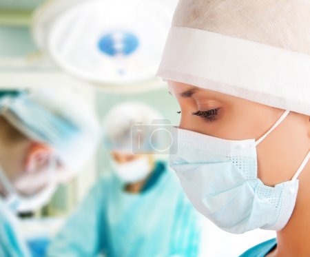 Young female surgeon in operation room
