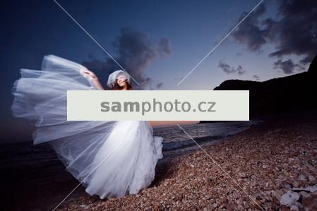 Bride on sunset beach