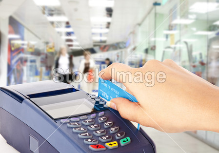 Human hand holding plastic card in payme