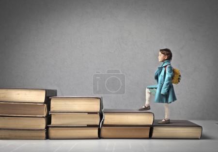 Baby Climbing a Ladder of Books