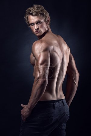 Strong Athletic Man Fitness Model posing back muscles