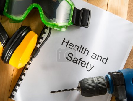 Health and safety Register with goggles, drill and earphones