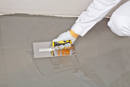 Spreading self leveling compound with trowel