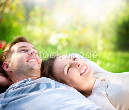 Young Couple Lying on Grass Outdoor