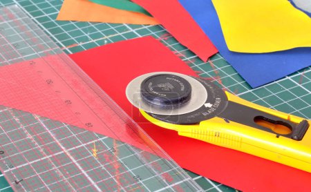 tools for patchwork: knife, ruler and cutting out the mat