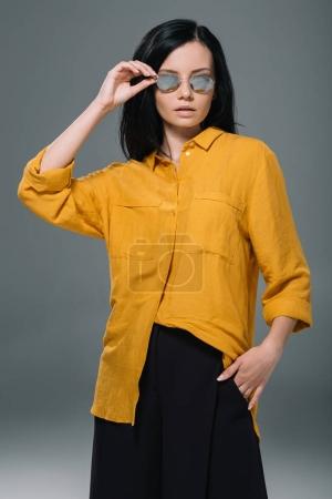 brunette woman in yellow blouse