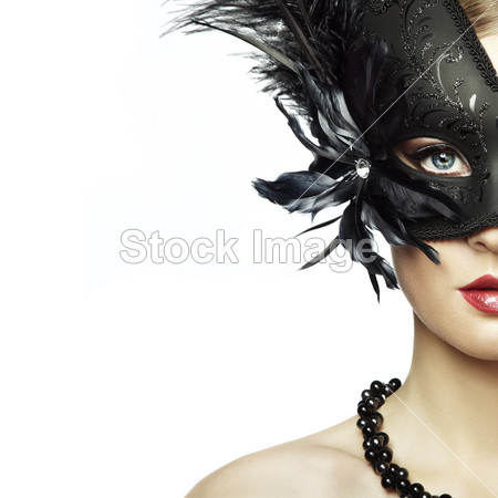Beautiful young woman in black mysterious venetian mask