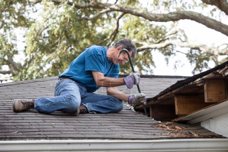 Man Repairing Leaking Roof