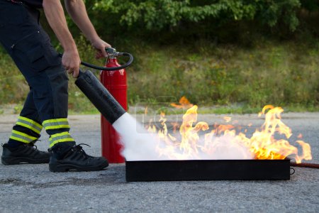 Instructor showwing fire extinguisher