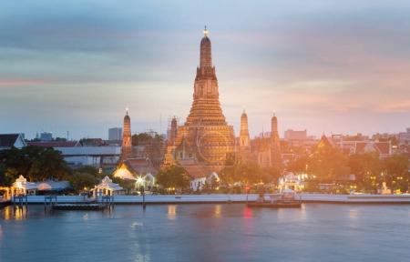 Wat Arun Bangkok Thailand landmark waterfront, during sunset 