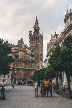view of city street wih Seville Cathedral, spain