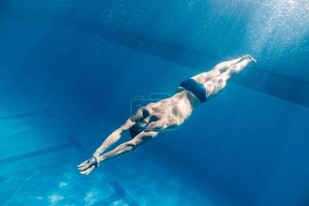 underwater picture of male swimmer swimming i swimming pool