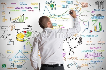 businessman drawing business graphics and symbols