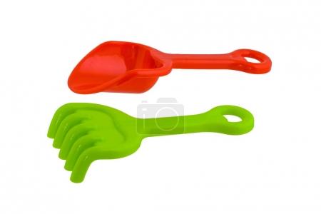 children's beach toys, Red spade and Green rake isolated on whit