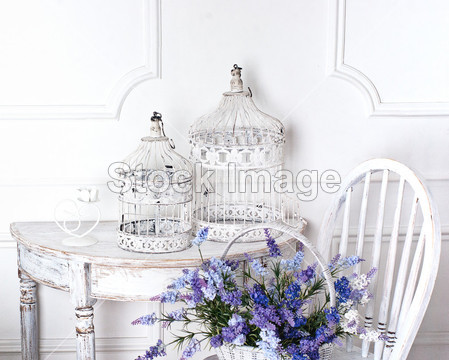 Vintage chair and table with flower in front and cages