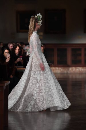 NEW YORK, NY - APRIL 12: A model walks the runway wearing Reem Acra Spring 2019 Bridal Collection at the New York Public Library on April 12, 2018 in New York City. 