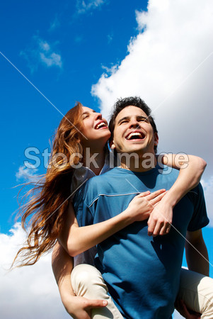 Happy Young couple against the sky