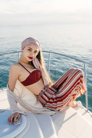beautiful young woman in summer clothes posing on a yacht, sailing on the Caribbean sea