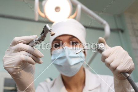 Dentist with instrument