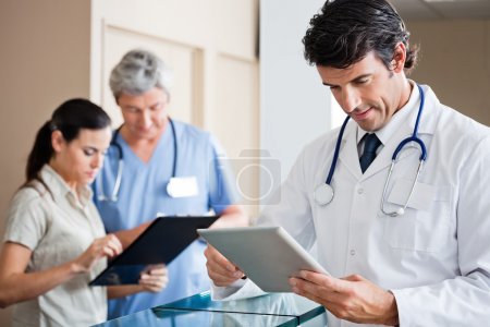 Male Doctor Holding Digital Tablet