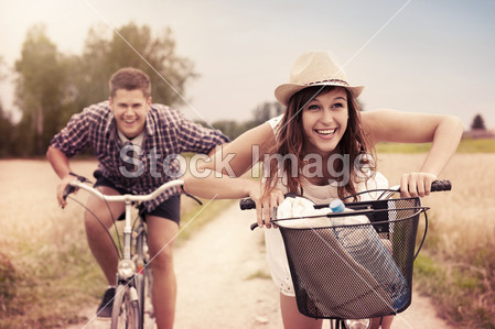 Couple racing on bikes