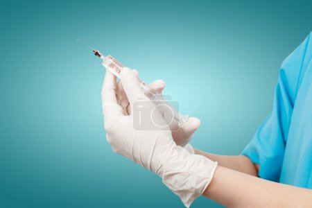 Doctor's hands holding syringe