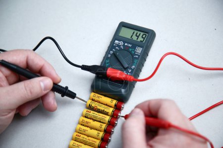 Krasnodar, Russia-November 18,2018. Checking the battery charge with a multimeter close-up.