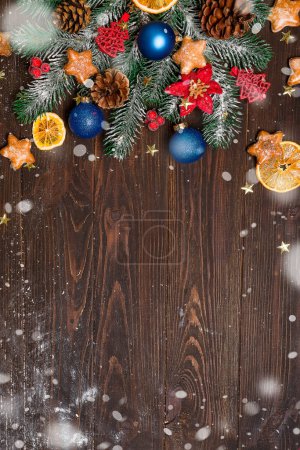 Christmas fir tree with decoration on dark wooden board. with copy space for text. Christmas mock-up or greeting card