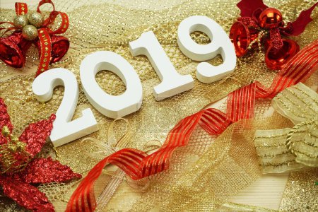 Happy New Year 2019 wooden number on shiny tinsel background