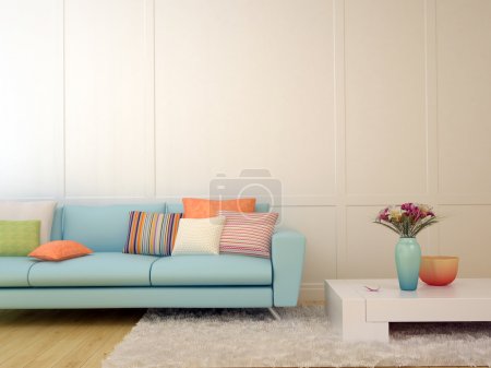 Blue sofa with colorful pillows and a white coffee table