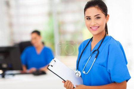 intern nurse holding a clipboard