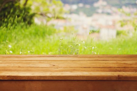 Empty wooden table over bokeh natural background