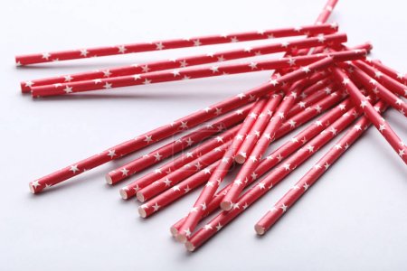 Red paper straws on grey background