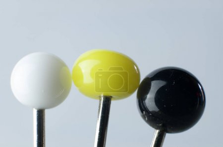 glass pin heads in white, yellow and black