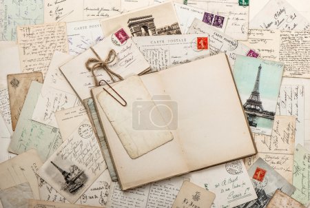 Open empty diary book, old letters, french postcards. scrapbook