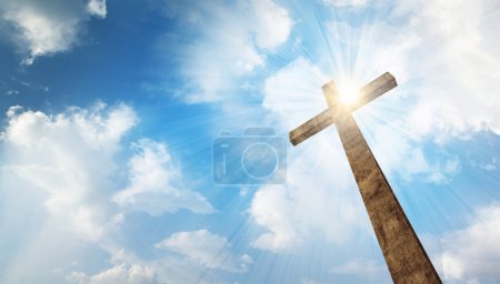 A wooden cross with sky