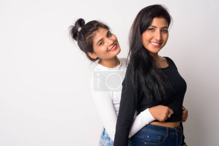 Two happy young beautiful Persian women embracing together