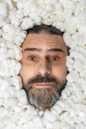 man covered in polystyrene packaging