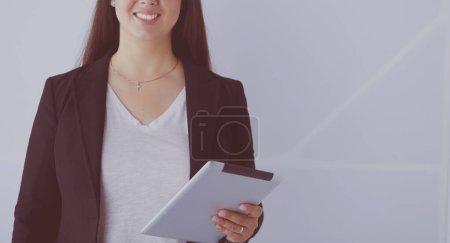 Portrait of smiling young business woman with digital tablet in her hands.