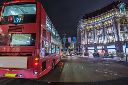 London, United Kingdom. Circa August 2017. Red double-decker bus. Pedestrian and traffic in Oxford Circus at night