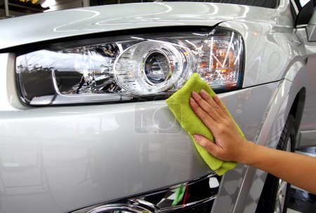 Hand with a wipe the car polishing car wash
