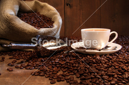 Coffee cup with burlap sack of roasted beans