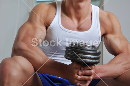 Powerful muscular man lifting weight