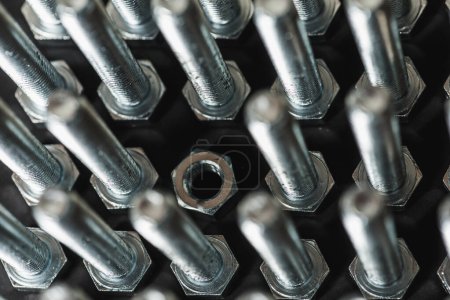Metal bolts and nuts in a row background. Chromed screw bolts and nuts isolated. Steel bolts and nuts pattern. Set of Nuts and bolts. Tools for work. Black and white