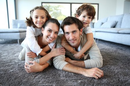Smiling family on carpet