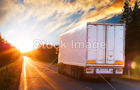 Truck on the asphalt road in the evening