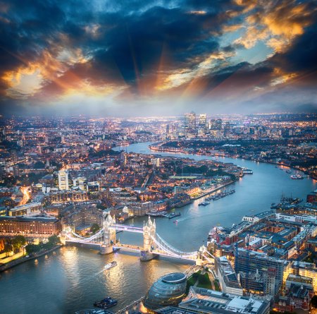 London. Aerial view of Tower Bridge at dusk with beautiful city
