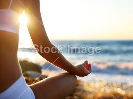 Body of a beautiful girl in a meditation on the beach